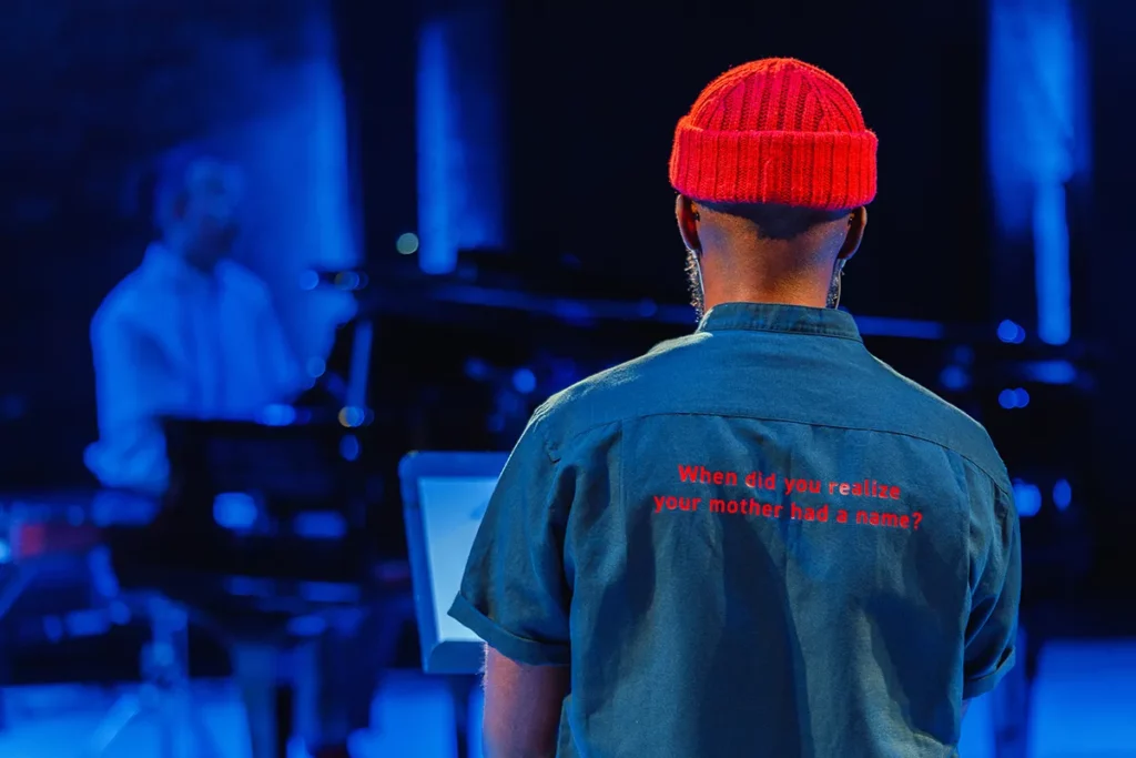Ian's back while on stage for LOSS. The back of his blue jean shirt reads "when did you realize your mom had a name?"