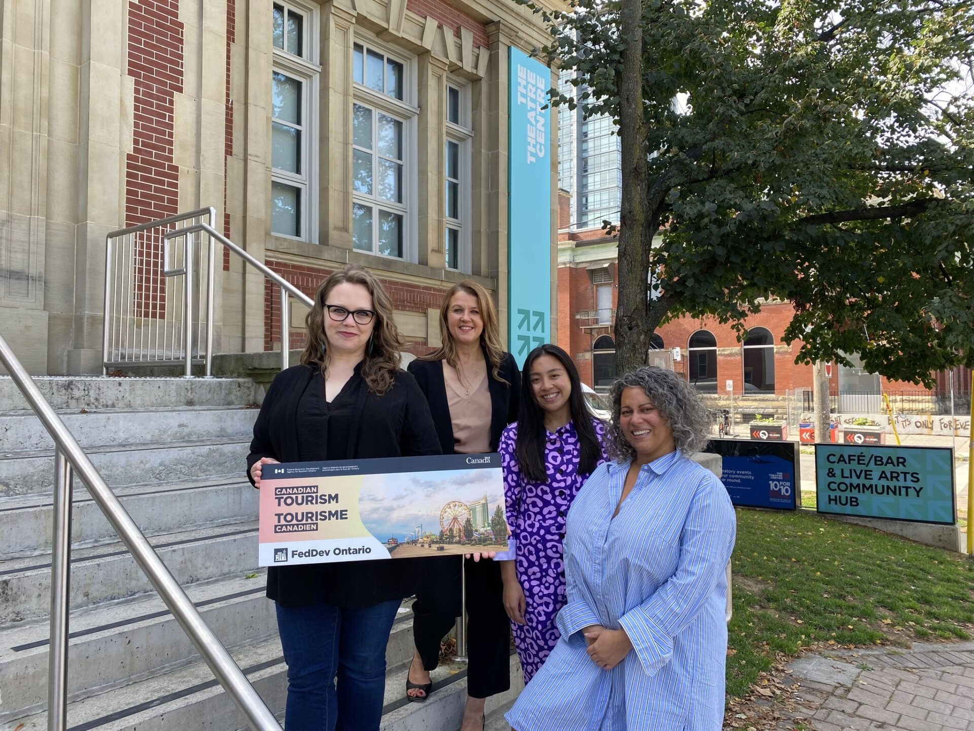 The photo features The Theatre Centre's leadership team on the front steps with Julie Dzerowicz, MP of Davenport.