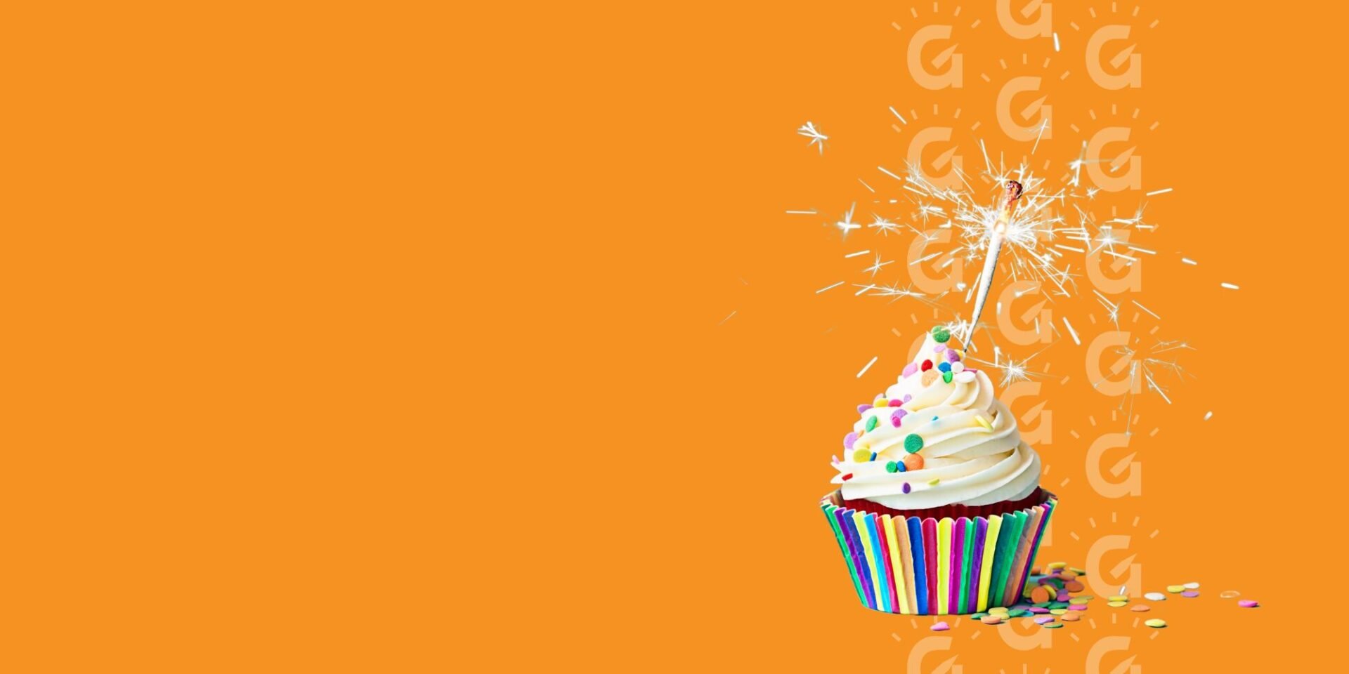 A bright orange graphic with a colourful birthday cupcake with one lit candle.